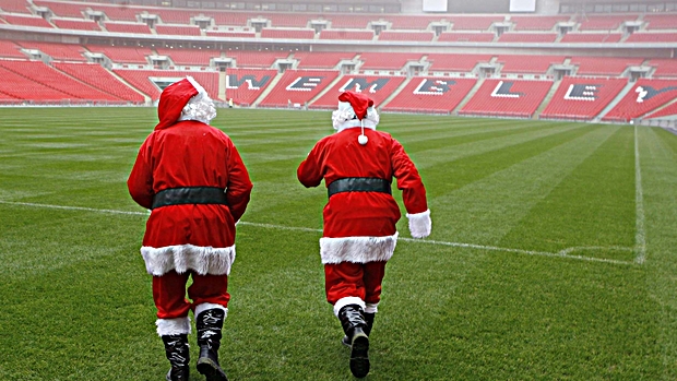 Wnsl Pr Shoot - Wembley National Stadium Limited PR Shoot 20/12/2006 - Wembley Stadium - 20/12/06 ;Groundsmen dressed as Santa walk on the grass